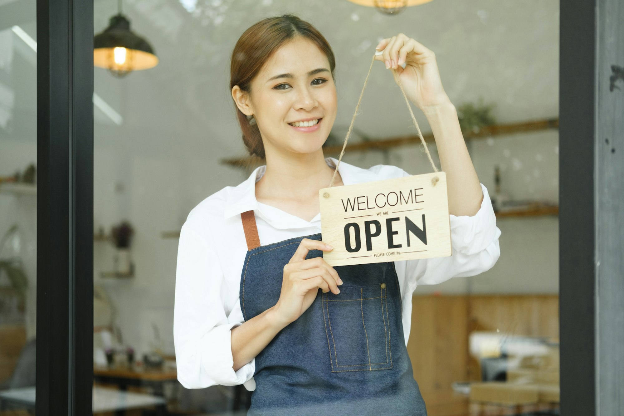 Young business owner open the coffee shop.